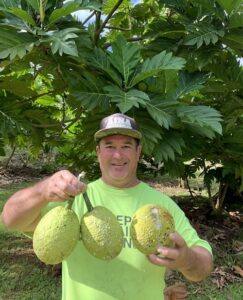 Person holding fruit and smiling