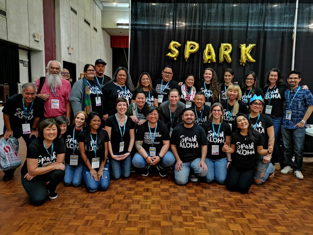 Group photo of SPARK team wearing black Spark Aloha shirts.