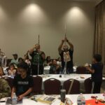 KPN2 parents and students build straw towers at our parent workshop activity