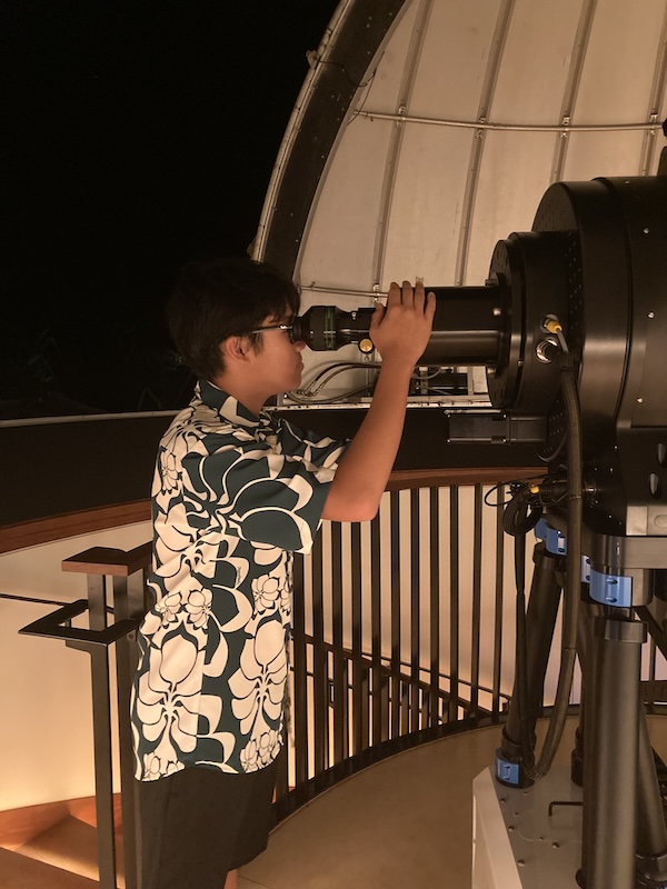 Student looking into telescope