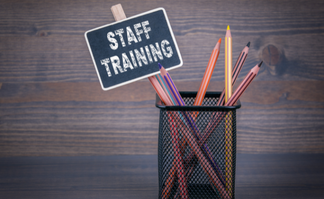 Staff Training sign with collection of pencils