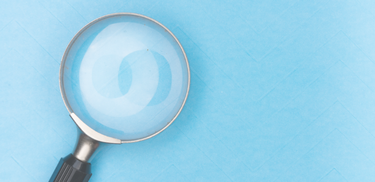 Image of a magnifying glass on a table.