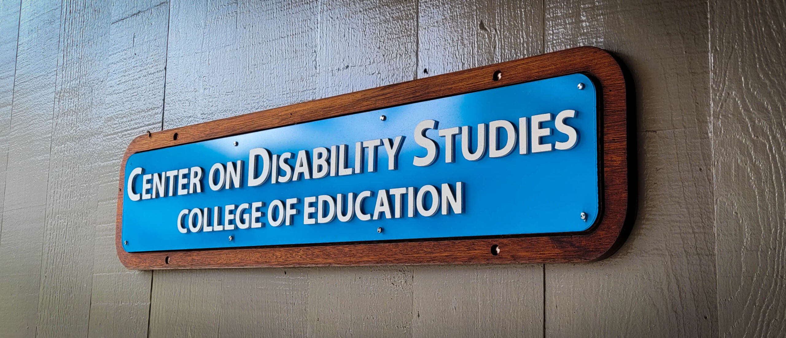 Image of the sign outside of the Center on Disability Studies that reads Center on Disability Studies College of Education.