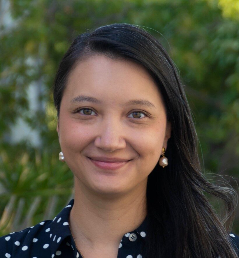 Maya Matheis Headshot with greenery background