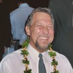 Bob Stodden smiling with lei around his neck.