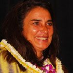 Charmaine_Crockett Charmaine Crockett smiling with a lei on.