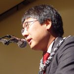 Jeffrey_Okamoto Jeffrey Okamoto with a lei on giving a speech.